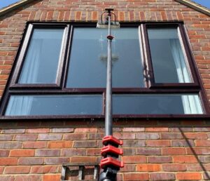 Window cleaner working on a home in Truro, Cornwall